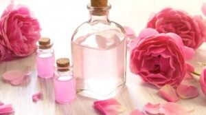 Bottle of rose water with fresh roses